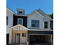 New construction townhome showcasing modern farmhouse elements and spacious garages at 4011 Redan Rd # 8, Stone Mountain, GA 30083