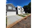 Two-story home with a gray exterior and white garage door at 4011 Redan Rd # 8, Stone Mountain, GA 30083