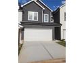 Two-story home with a gray exterior and white garage door at 4011 Redan Rd # 8, Stone Mountain, GA 30083