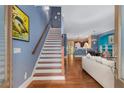 Welcoming entryway with hardwood floors, staircase, and open layout to the living areas at 396 15Th Nw St # 6, Atlanta, GA 30318