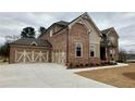 Stunning brick home featuring a spacious three-car garage and professionally landscaped yard at 4020 Sierra Knolls Ct, Cumming, GA 30040