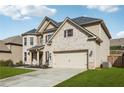 Charming two-story brick home with a well-manicured lawn and attached two-car garage at 5180 Mirror Lake Dr, Cumming, GA 30028