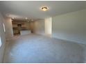 Open-concept living room with a view into the kitchen, providing ample space for relaxation and entertainment at 1006 Starmoss Lane, Conyers, GA 30094