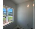 Bright, sunlit room featuring a large window showcasing exterior views and a neutral color palette at 1006 Starmoss Lane, Conyers, GA 30094