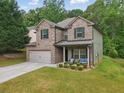 Beautiful two-story home featuring brick and siding exterior with manicured lawn at 11028 Southwood Dr, Hampton, GA 30228