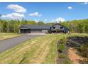 Beautifully landscaped yard leads to a Craftsman-style home with an attached two-car garage at 281 Abbott Dr, Canton, GA 30114