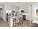 Well-lit kitchen with stainless steel appliances and granite countertops, complemented by stylish bar seating at 488 Village Ln, Fairburn, GA 30213