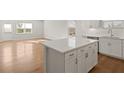 Spacious kitchen with a large island, white cabinets, and modern finishes at 488 Village Ln, Fairburn, GA 30213