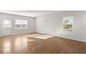A large, light-filled living area with hardwood floors and a view to the windows at 488 Village Ln, Fairburn, GA 30213