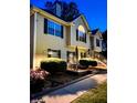 Charming two-story home with a well-manicured lawn, lush landscaping, and welcoming entrance stairs at 3809 Autumn View Nw Ln, Acworth, GA 30101