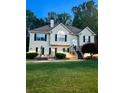 Charming two-story home features a landscaped front yard with a quaint patio seating area at 3809 Autumn View Nw Ln, Acworth, GA 30101