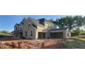 Side view of a brick home with an attached two car garage, situated on a sprawling lot with natural surroundings at 4015 Sierra Vista Cir, Cumming, GA 30040