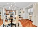 Dining area with modern light fixture and hardwood floors, adjacent to open kitchen at 200 River Vista Dr # 436, Atlanta, GA 30339