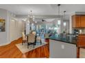 Open concept living area with dining table, ceiling fan, and hardwood floors at 200 River Vista Dr # 436, Atlanta, GA 30339