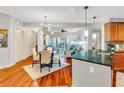 Bright open-concept space showcasing kitchen, dining, and living areas with hardwood floors at 200 River Vista Dr # 436, Atlanta, GA 30339