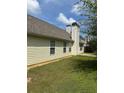 Exterior view of home highlighting neutral siding, chimney, and well-maintained lawn at 3218 Watson Woods Way, Loganville, GA 30052
