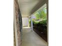 Side view of walkway featuring stone, shrubs, manicured mulch, and siding at 3218 Watson Woods Way, Loganville, GA 30052