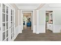 Bright hallway with neutral walls, hardwood flooring, and elegant white trim at 4325 Acanthite Ct, Cumming, GA 30040