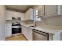 Well-equipped kitchen with stainless steel appliances, updated cabinets, and ample counter space at 64 Dogwood Rdg, Hampton, GA 30228