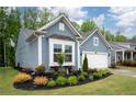 A lovely single-Gathering home with light blue siding, a bay window, and a well-manicured lawn and shrubbery at 109 Aspen Way, Dallas, GA 30157