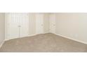 Spacious bedroom with neutral walls, plush carpeting, two double door closets, and base molding, offering a serene atmosphere at 194 Wilhelmina Dr, Austell, GA 30168