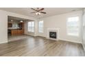 Spacious living room featuring a fireplace, ceiling fan and wood-look flooring at 194 Wilhelmina Dr, Austell, GA 30168