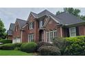 Beautiful red brick home with manicured lawn and elegant architectural details at 3348 Perrington Pointe, Marietta, GA 30066