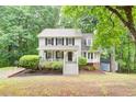 Inviting two-story home with a front porch, complemented by lush trees and landscaping around the property at 3480 Stillridge Dr, Alpharetta, GA 30022