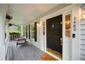 View of the front door with a 'Happy Home' welcome mat on a porch with chairs and the house number at 3480 Stillridge Dr, Alpharetta, GA 30022