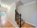 A well lit hallway features wood floors and a carpeted staircase at 3480 Stillridge Dr, Alpharetta, GA 30022