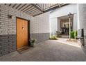 Condominium entrance with brick veneer walls, wood door, and walkway to units and stairwell at 3501 Roswell Ne Rd # 102, Atlanta, GA 30305