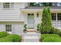 Inviting front entrance with white brick, potted greenery, and stylish light fixture enhancing the home's appeal at 1518 Rochelle Dr, Atlanta, GA 30338