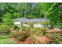 Well-maintained home with beautifully landscaped front yard featuring colorful flowers and lush greenery at 1518 Rochelle Dr, Atlanta, GA 30338