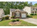 Well-maintained brick home showcasing a convenient attached garage and a neatly manicured front lawn at 171 Nacoochee Way, Canton, GA 30114