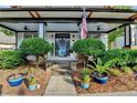 Inviting front porch with patriotic decor, a colorful door wreath, and well-manicured landscaping at 178 Mission Oak Dr, Grayson, GA 30017