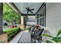 Relaxing front porch with wicker furniture, ceiling fan, and view of the tree-lined street at 178 Mission Oak Dr, Grayson, GA 30017