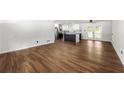 Open-concept living room showcasing hardwood floors and a modern kitchen with stainless steel appliances at 4158 Pepperdine Dr, Decatur, GA 30034