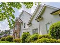 An elegant two-story home showcasing a combination of stone and stucco, enhanced by well-maintained shrubbery at 725 Eider Down Ct, Alpharetta, GA 30022