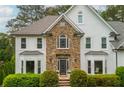 Charming two-story house featuring a stone-accented facade, bay windows, and manicured landscaping for curb appeal at 725 Eider Down Ct, Alpharetta, GA 30022