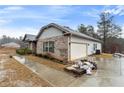Side view of the beautiful home featuring a spacious two-car garage and brick and siding combination at 8268 E Carroll Rd, Whitesburg, GA 30185