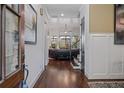 Inviting foyer featuring hardwood floors, white wainscoting, a stairway to the second floor, and views into the living room at 2490 Hillandale Cir, Cumming, GA 30041