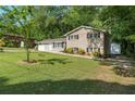 Two-story home with brick facade, attached garage, and a spacious front lawn at 4070 Lauada Dr, Douglasville, GA 30135