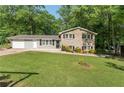 Charming two-story home with a brick facade, well-maintained lawn, and mature trees at 4070 Lauada Dr, Douglasville, GA 30135