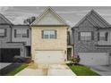 Charming townhomes feature brick exteriors, well-manicured lawns, and attached garages at 241 Irwell Path, Lawrenceville, GA 30044
