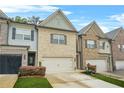 Charming townhomes feature brick exteriors, well-manicured lawns, and attached garages at 241 Irwell Path, Lawrenceville, GA 30044
