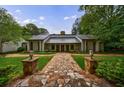 Inviting home featuring a stone walkway, manicured lawn, and sophisticated landscaping at 5120 Jett Forest Trl, Atlanta, GA 30327
