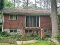 Brick home featuring a partially dismantled deck, offering outdoor living and entertaining potential at 5211 Hugh Howell Rd, Stone Mountain, GA 30087