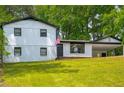 Inviting exterior view of a charming two-story home with manicured lawn and a convenient carport at 157 Jousters Ln, Lawrenceville, GA 30044