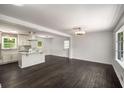 Bright living area featuring hardwood floors and ample natural light, flowing into the kitchen at 157 Jousters Ln, Lawrenceville, GA 30044