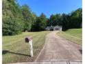 Exterior angle of single story home with long driveway and grassy front yard at 332 Christian Ln, Carrollton, GA 30116